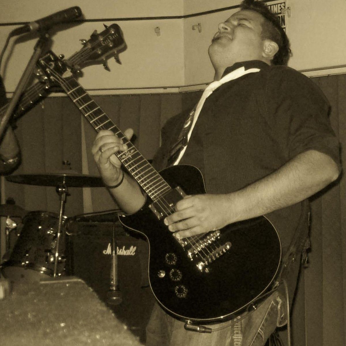 Niven Markus playing electric guitar at a live gig